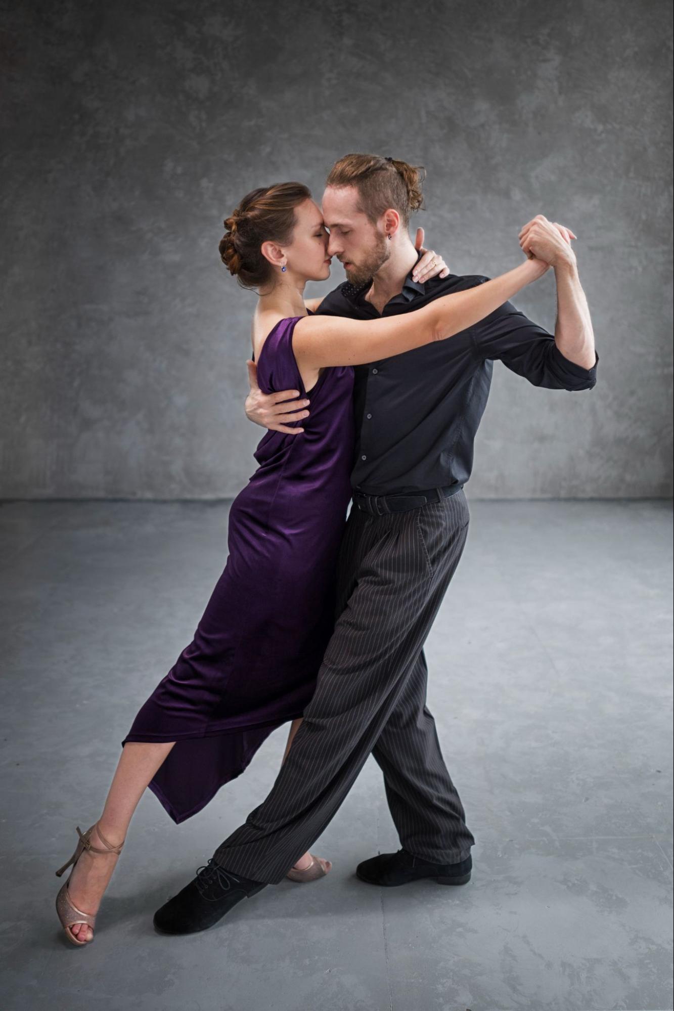 Couple learning Bachata in an RF Dance class